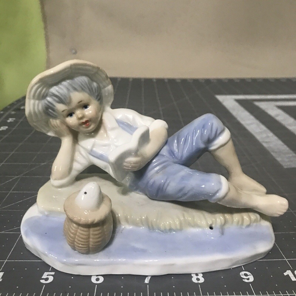 Vintage Porcelain Blue and White Boy Fish Figurine Propped Elbow Reading